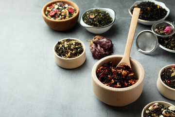 Many different herbal teas on grey table