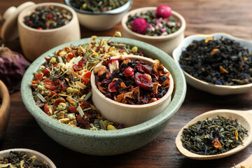 Many different herbal teas on wooden table