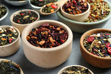 Many different herbal teas on grey table