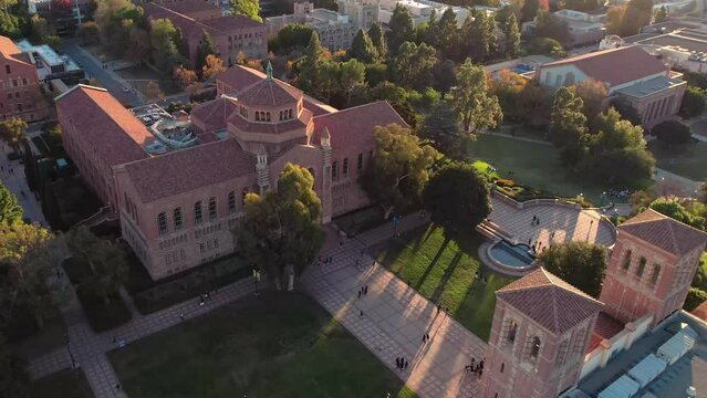 Aerial view orbiting UCLA Dickinson court pristine university campus at sunset