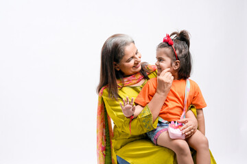 Indian grandmother with her granddaughter on white background.