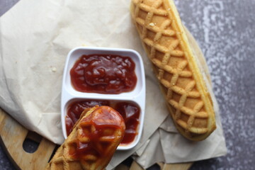 Top View Dog Waffles on a Stick and Tomato Sauce Place it on a gray table.