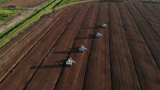 Drone shooting. Harvesting peat with combines. Peat extraction process. Agriculture industry.