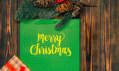 Christmas wooden background with fir branches and gifts with a place to copy.