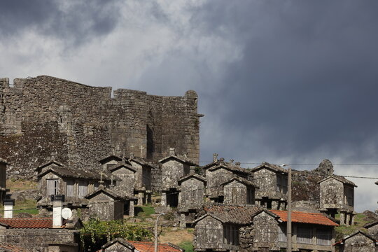 An old Granary (espigueiros) and castle above the village of Lindoso in the Parque Nacional da Peneda-Geres in northern Portugal.