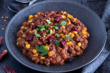 A large bowl of homemade black bean and corn chili, ready for eating.