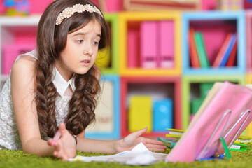 Portrait of cute little girl study at home 