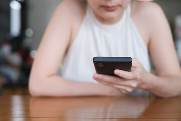 Woman hand holding and using smartphone, tablet, cell phone touching on screen. mobile phone application technology. copy space for text.