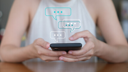 hand using smartphone typing, chatting on application Communication and conversation,mail working, in chat box icons pop up. Social media maketing technology concept.