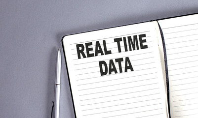 REAL TIME DATA word on the notebook with pen
