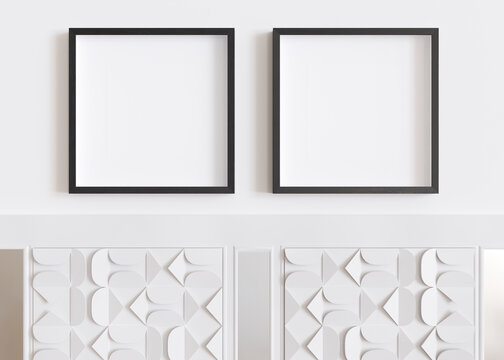 Two blank square picture frames hanging on white wall. Template, mock up for artwork, picture or poster. Empty, copy space. Close up view. Simple, minimalist mockup. 3D rendering.