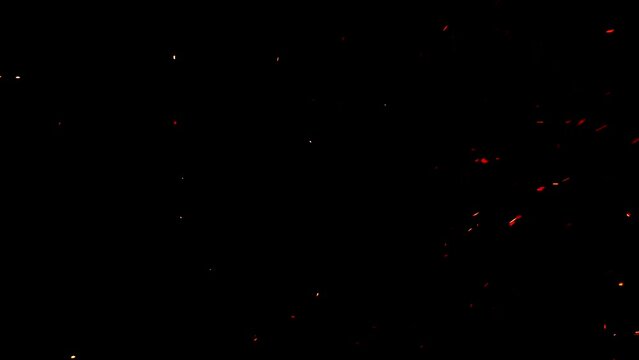 Glowing embers floating in the night sky. Buring particle ash in orange red and yellow colors. Ideal to use as an overlay