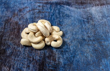 Organic Cashew Nut Isolated on Blue Textured Background with Copy Space for Texts Writing