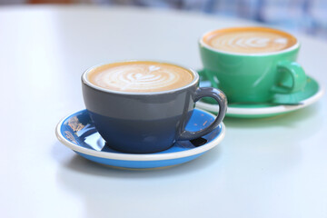 Two cup of delicious and fragrant cappuccino on a wooden table. Selective focus.