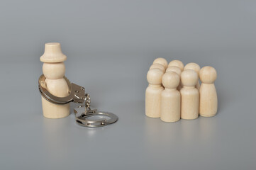 Prisoner with handcuff in front the workers. Corruption, crime due to fraud, money laundering business or supply chain scam