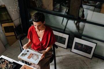 European woman working with tablet computer and interior samples