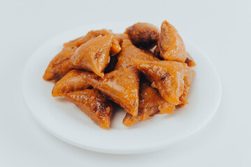 close up of Moroccan Almond Briouats Served in plat - A briouat or briwat is a sweet or savory puff pastry.