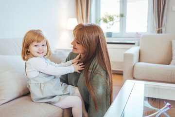 Mom embracing her daughter with love, red haired girls enjoy spending time together. Close up...