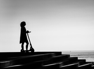 silhouette of a person walking on a bridge