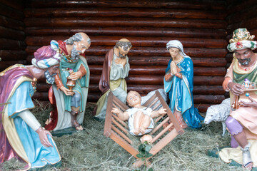 Nativity scene with figurines of Jesus, Mary, Joseph, sheep and wise men.