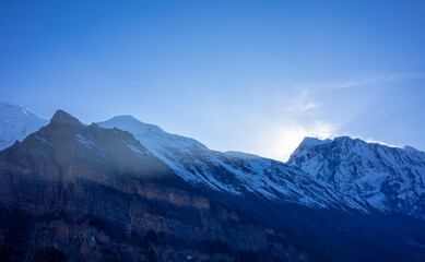 Sunrise over the mountains of Anapurna in Nepal. Snowy mountain peaks and blue sky as copy space.
