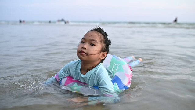 Asian girl play sea with fun,Summer time with family,Children's semester break activities
