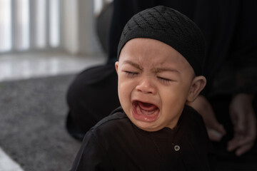 Close up, crying baby Muslim boy, Muslim boy wear black traditional suit - obrazy, fototapety, plakaty