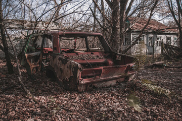 Destroyed abandoned Soviet car in the exclusion zone, Pripyat region, Chernobyl disaster, Ukraine