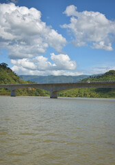 Obraz premium Bridge over the Mekong River in Lao PDR, the scenery on both sides of the Mekong River in Lao PDR, native boats use water travel.
