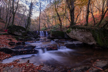 Waterfall view in autumn. The autumn colors surrounding the waterfall offer a visual feast. colorful leaves of autumn. Suuctu waterfalls, Bursa, Turkey.