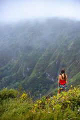 Fototapeta premium girl in pigtails stands at the top of the kuliouou ridge trail admiring the panorama of oahu, honolulu and the hawaiian mountains; hiking in the mountains in hawaii, holiday in hawaii