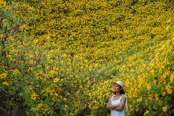 Outdoor portrait of a beautiful asian woman. attractive sexy girl in a field with flowers