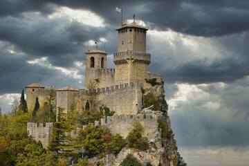 Castle on a rock in Republic of San Marino, HDR image with clouds in background