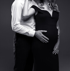 couple expecting a baby, black and white photo of a beautiful couple of a man and pregnant woman