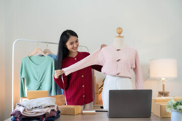 Portrait of Starting small businesses SME owners, Asian woman check online orders Selling products...