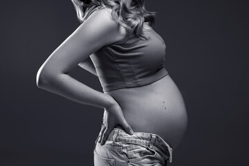 pregnancy woman holding belly with hands on belly