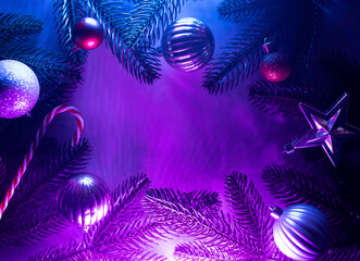 Christmas layout with christmas tree branches, christmas decorations in vibrant neon glow. copy...