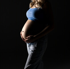 pregnancy woman holding her belly, pregnant silhouette on a black background