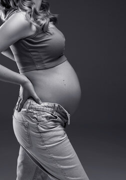 pregnancy woman holding her belly, pregnant belly close up, black and white photo