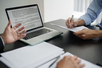 Lawyer preparing to sign a contract and wooden gavel on table justice and law concept.