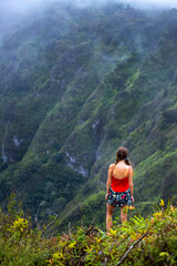 Fototapeta premium girl in pigtails stands at the top of the kuliouou ridge trail admiring the panorama of oahu, honolulu and the hawaiian mountains; hiking in the mountains in hawaii, holiday in hawaii