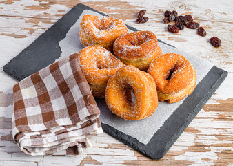 aniseed doughnuts on a paper and a blackboard
