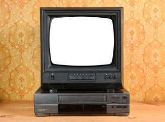 Old black vintage TV with white screen and VCR on wallpaper background.