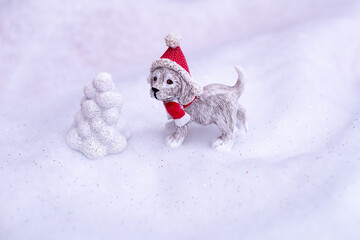dog in santas hat in winter landscape miniature decoration