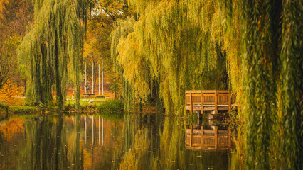 Park on Orunia in Gdansk in the autumn season. View of the pond and colorful trees.