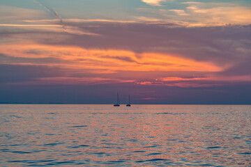 The tourist ship is putting out to sea sunset at mediterranean sea. Italian Riviera. Postcard view. Zadar, Croatia.