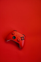 Gamepad on a red background. Game concept, esports, leisure, gaming industry, video games. Flat lay, top view © Мария Охметзянова