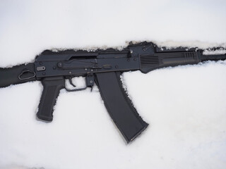Black metal gun machine in snow