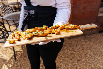 Wedding reception event party catering with appetisers and canapés being served by servers in the garden for their guests