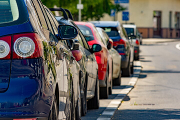 Close up to a row of parked cars on the side of a street in a residential or urban area - 548810294